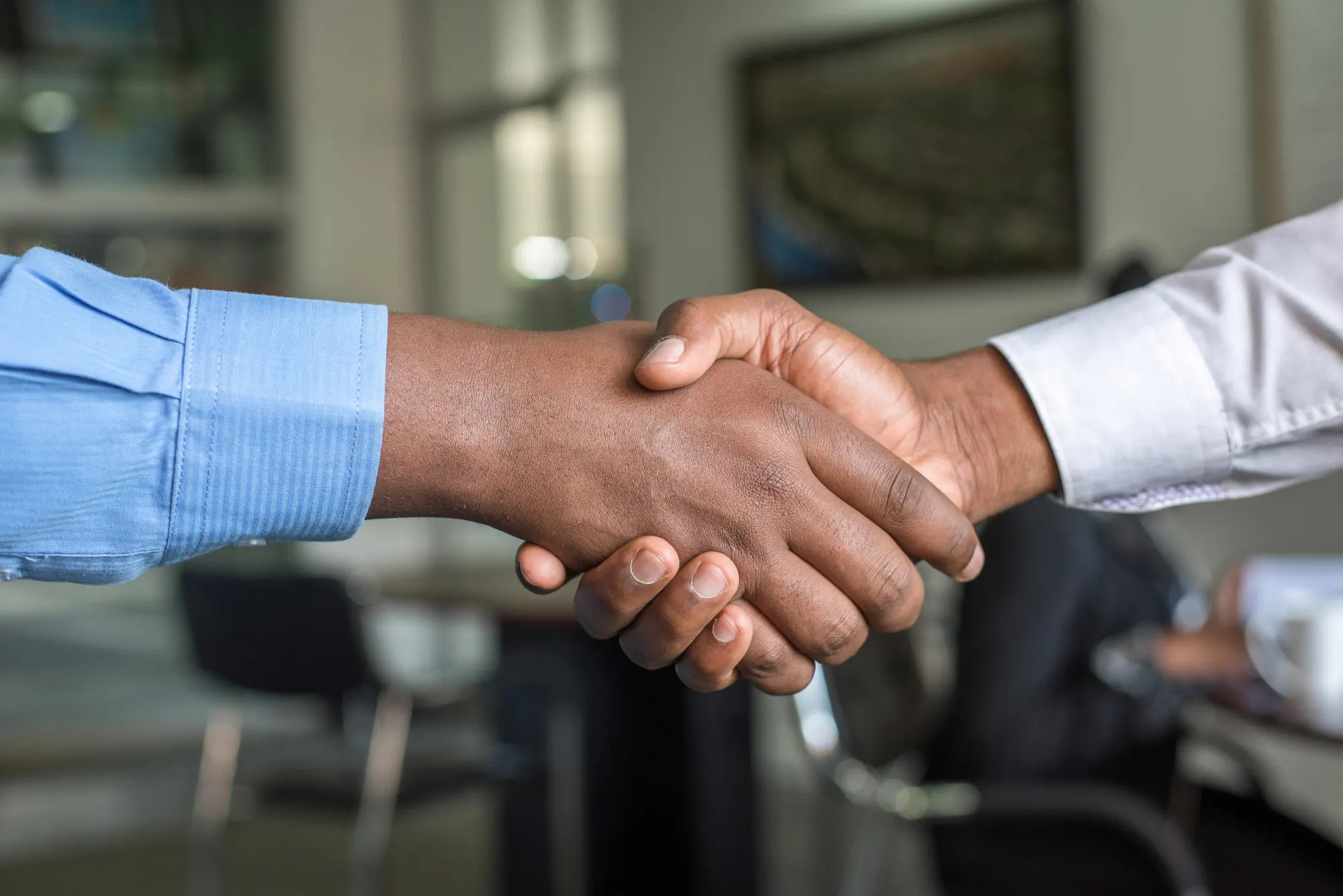 Two people shaking hands after a meeting